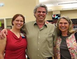 three smiling people